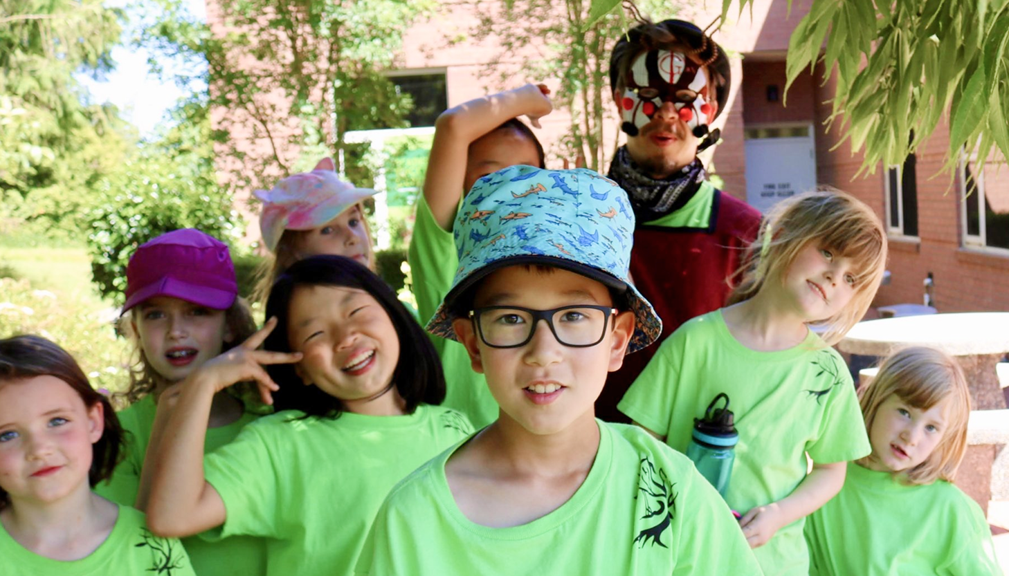 Kids dress up and play theatre at a day camp outside